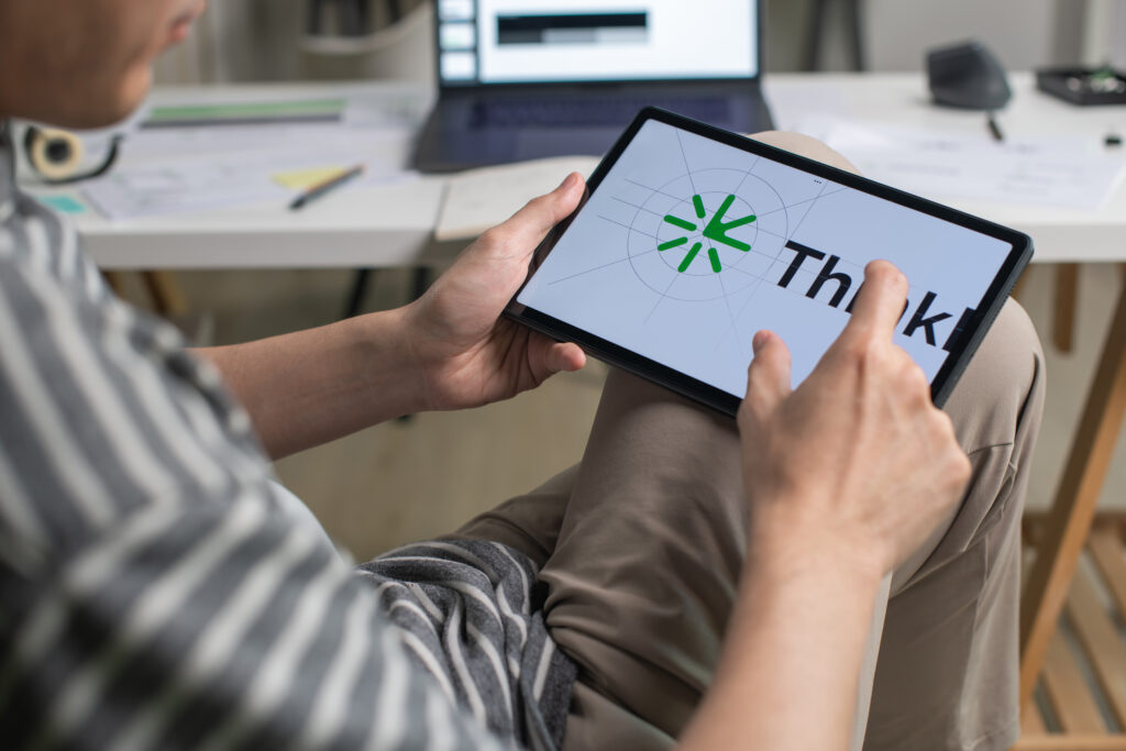 graphic designer working in an office studio, using tablet, designing logos and showcasing the corporate identity and logo design process.